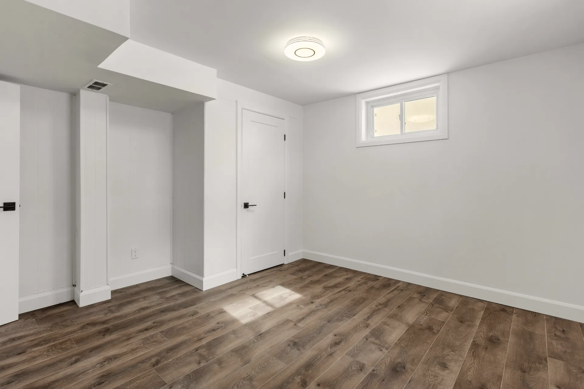New laminate flooring installed in a bright Vancouver basement suite