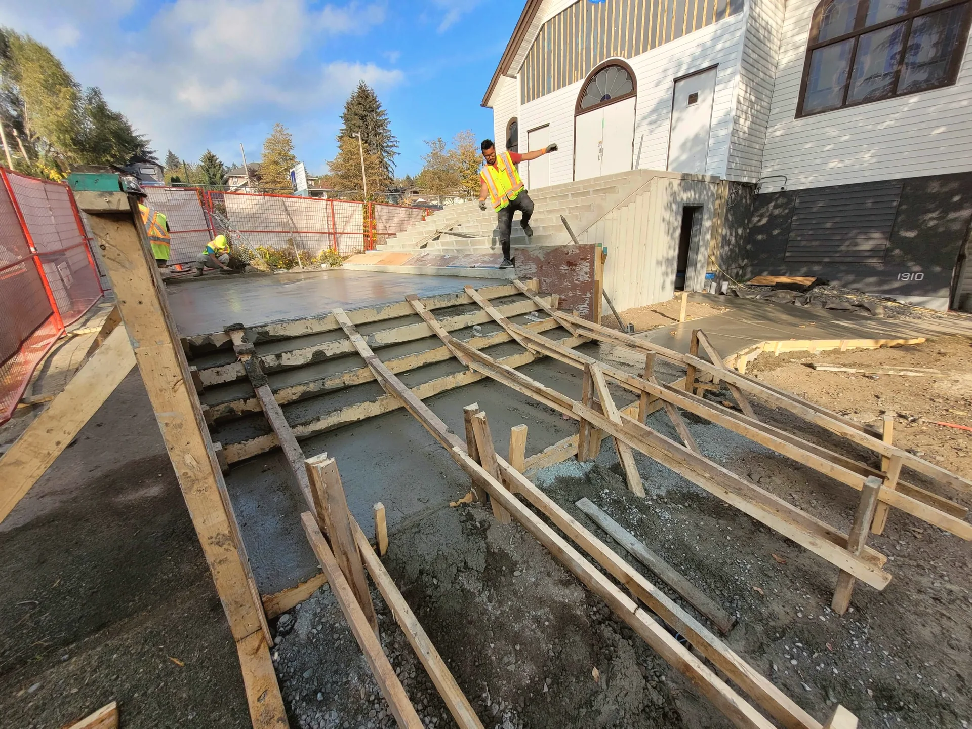 Concrete pour on wide church entrance stairs with fresh formwork