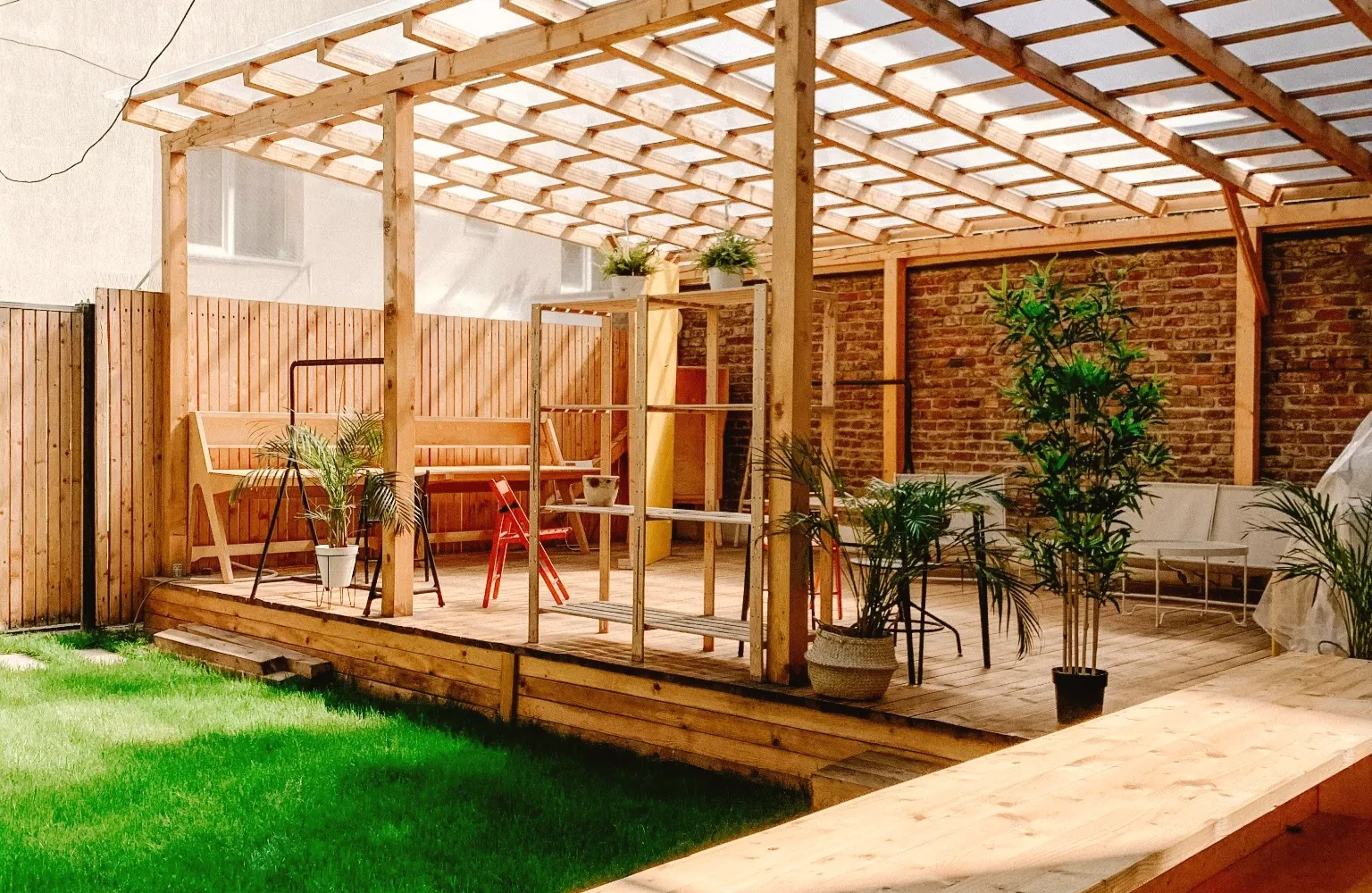 Warm covered cedar pergola with green backyard